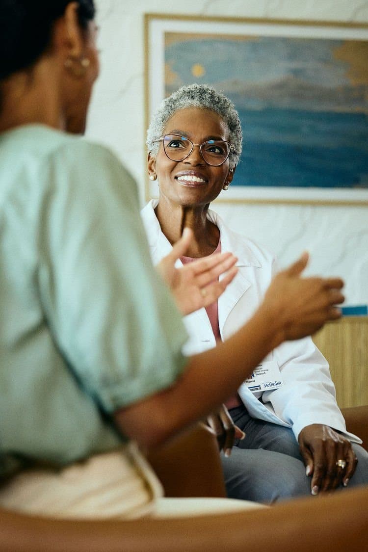 Smiling care professional in conversation with a trainee